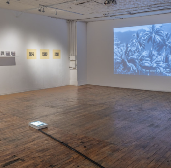 exhibition view of gallery with projected photograph
                  